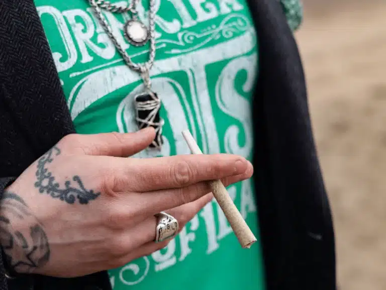 closeup of a person's hand holding a pre-roll