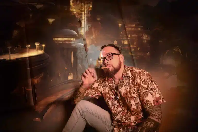 Man smoking in front of fantastical background