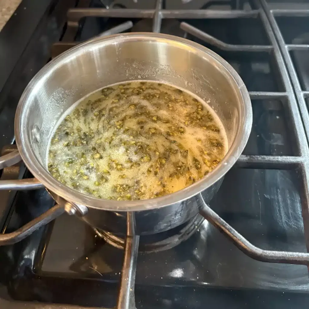 Cannabis pieces swirling in melted butter