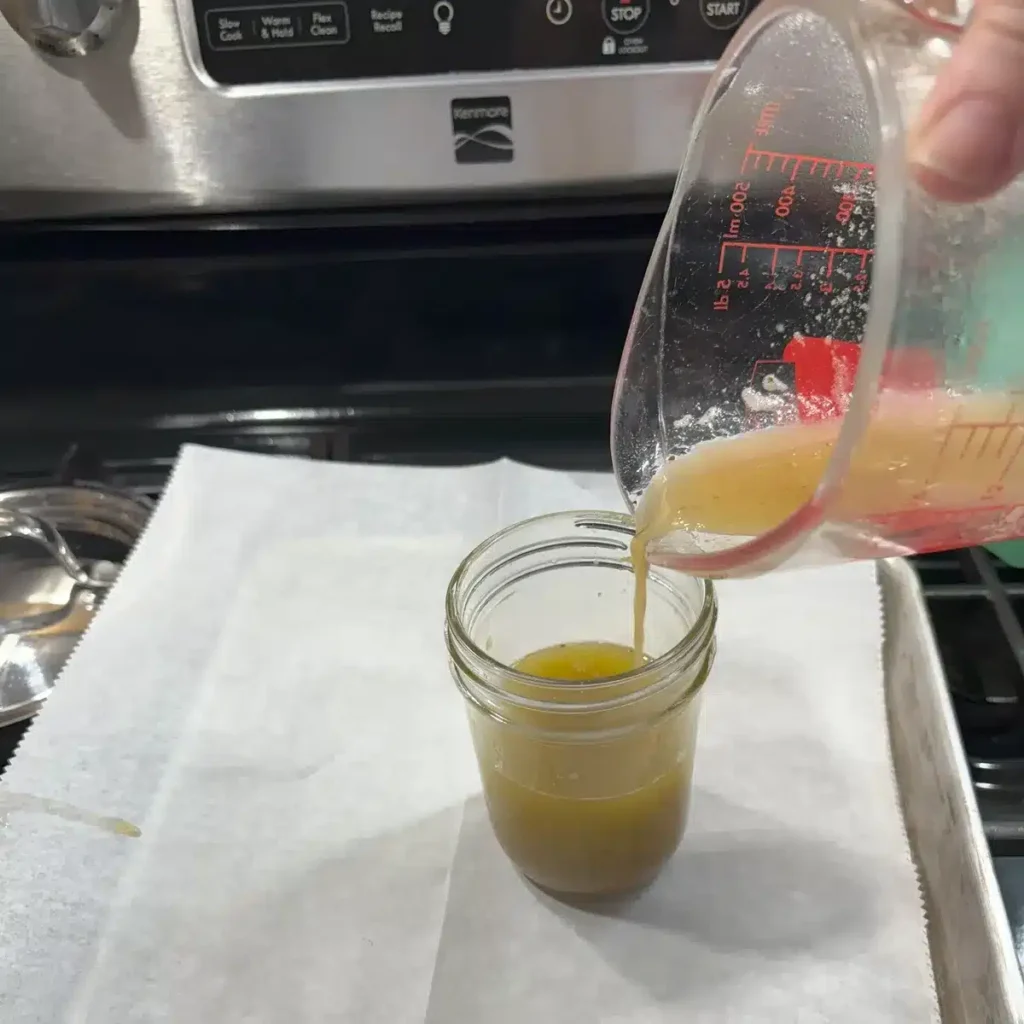 Pour strained liquid into mason jar